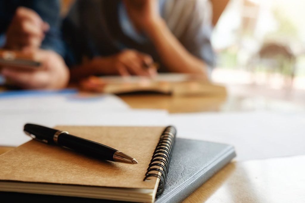 education-concept-student-studying-and-brainstorming-campus-concept-close-up-of-students-discussing-their-subject-on-books-or-textbooks-selective-focus-1-1-scaled