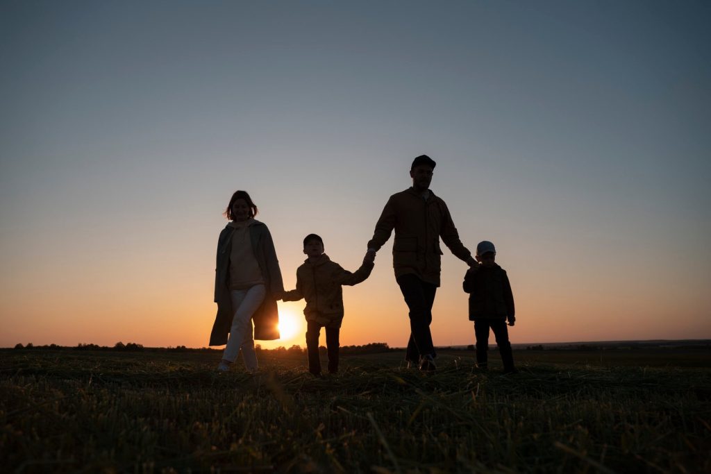 full-shot-family-silhouette-having-fun-sunset-scaled