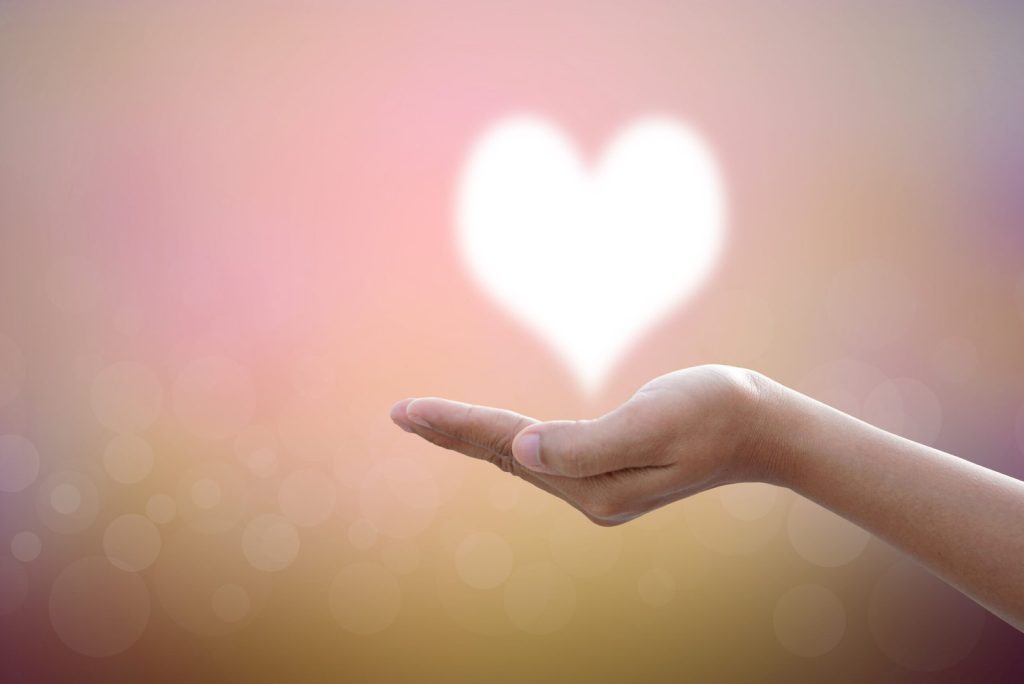 hands-bless-heart-in-the-skyblurred-nature-background-scaled