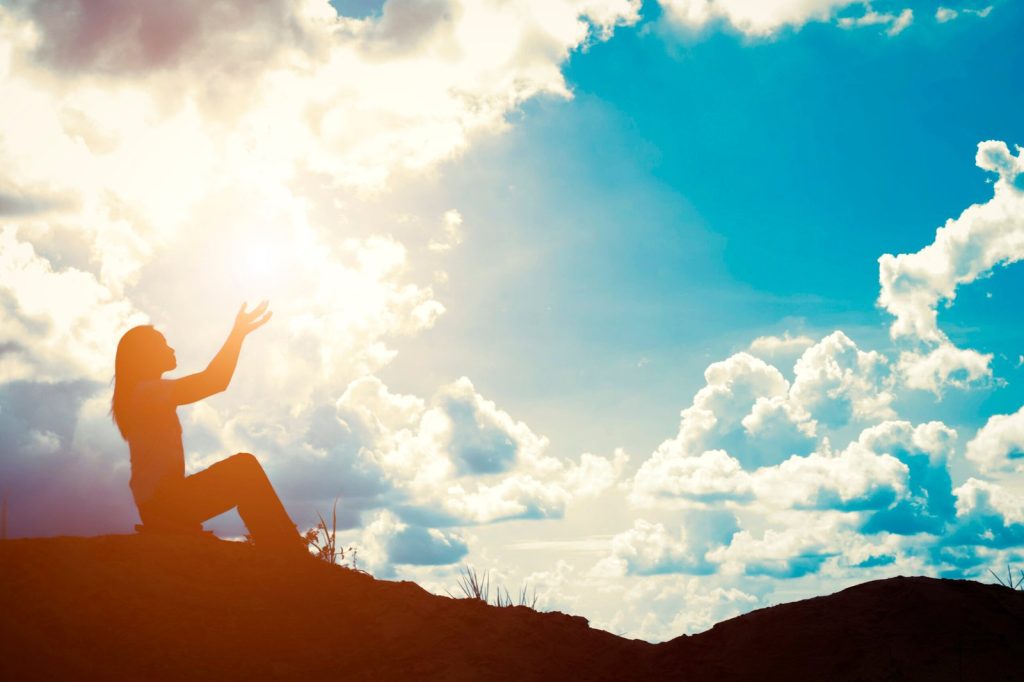 silhouette-of-woman-with-raised-hands-scaled