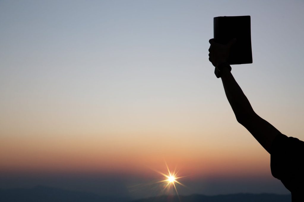 spiritual-prayer-hands-holding-the-bible-scaled