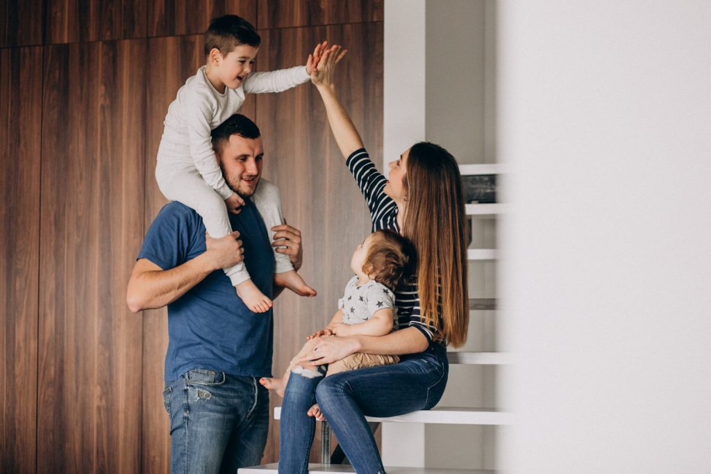 young-family-with-their-little-son-at-home-having-fun-scaled