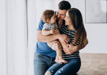 Young family with their little son at home